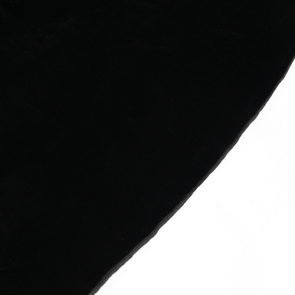 Close-up of luxurious black velvet fabric, showcasing its rich texture and deep color contrast.